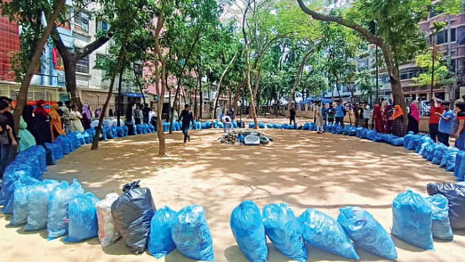 Discarded tyres and bottles being cleared from a vacant lot